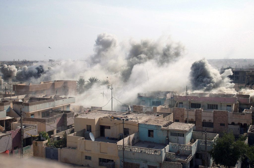 A confirmed insurgent stronghold goes up in smoke after a strategic aerial strike during combat operations while US Marine Corps (USMC) Marines, 1st Battalion (BN), 8th Marine Regiment (1/8), search for insurgents and weapon caches during a Security and Stabilization Operation (SASO) conducted as part of Operation AL FAJR, which is an offensive operation to eradicate enemy insurgents in Fallujah, Al Anbar Province, Iraq, during Operation IRAQI FREEDOM.